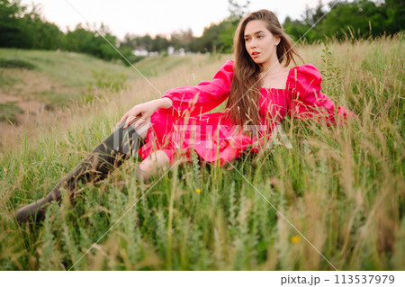 Happy woman in the blooming field. Nature, vacation, relax and lifestyle. Summer landscape. 113537979