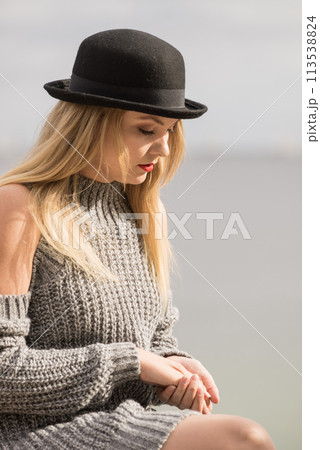 Woman wearing fedora and jumper outdoor Woman wearing fedora and jumper outdoor 113538824