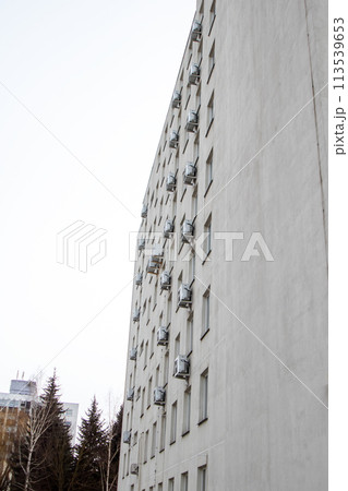 Windows of multi-storey tall building against background of sky Windows of multi-storey tall building against background of sky 113539653