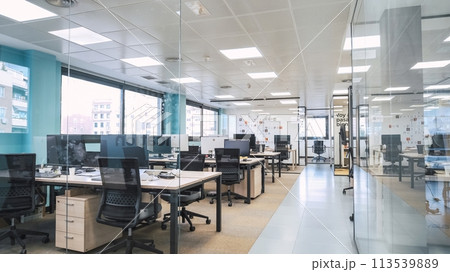 Interior of creative coworking workspace with computer desks 113539889
