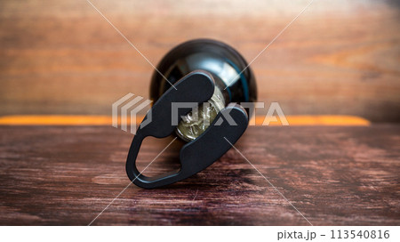 Wine bottle and bottle opener on wooden background Wine bottle and bottle opener on wooden background 113540816