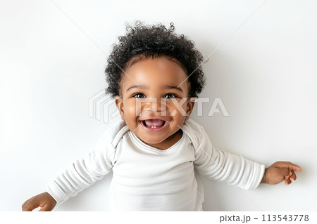 Cute and playful portrait of happy 1.5 years old child playing on white bright solid studio background, top view. Funny face. Baby Development. Child's emotions. Cheerful One year old kid having fun Cute and playful portrait of happy 1.5 years old child playing on white bright solid studio background, top view. Funny face. Baby Development. Child's emotions. Cheerful One year old kid having fun 113543778