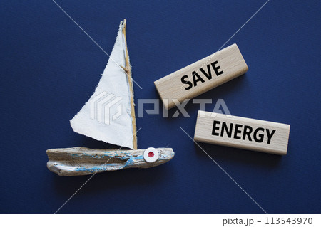 Save Energy symbol. Wooden blocks with words Save Energy. Beautiful deep blue background with boat. Business and Save Energy concept. Copy space. Save Energy symbol. Wooden blocks with words Save Energy. Beautiful deep blue background with boat. Business and Save Energy concept. Copy space. 113543970