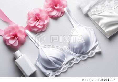 White lacy lingerie on white background. Sexy bra, panties flat lay, top view. Horizontal banner with copy space for text. No people. Fashion lingerie set, essential accessory and stylish underwear. 113544117