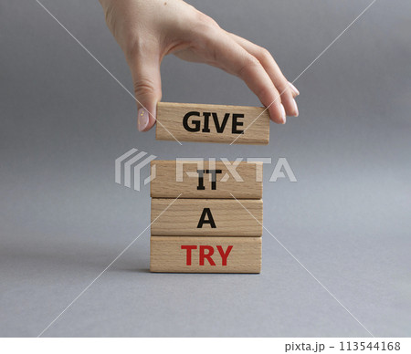 Give it a try symbol. Concept words Give it a try on wooden blocks. Beautiful grey background. Businessman hand. Business and Give it a try concept. Copy space. Give it a try symbol. Concept words Give it a try on wooden blocks. Beautiful grey background. Businessman hand. Business and Give it a try concept. Copy space. 113544168