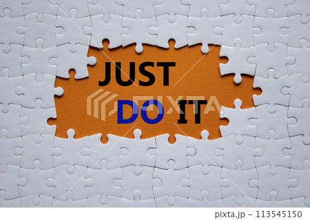 Just do it symbol. Concept words Just do it on white puzzle. Beautiful orange background. Business and Just do it concept. Copy space. 113545150