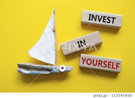 Invest in Yourself symbol. Concept words Invest in Yourself on wooden blocks. Beautiful yellow background with boat. Business and Invest in Yourself concept. Copy space. Invest in Yourself symbol. Concept words Invest in Yourself on wooden blocks. Beautiful yellow background with boat. Business and Invest in Yourself concept. Copy space. 113545939