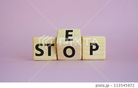 Step vs Stop symbol. Wooden cubes with words Stop and Step. Beautiful pink background. Step vs Stop and business concept. Copy space 113545972