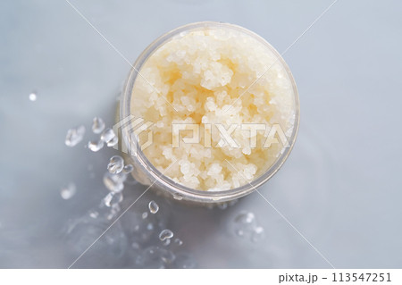 Body scrub on a blue background with water. 113547251