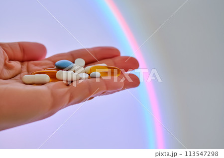 Vitamins and dietary supplements on the palm against the luminous circle. Vitamins and dietary supplements on the palm against the luminous circle. 113547298