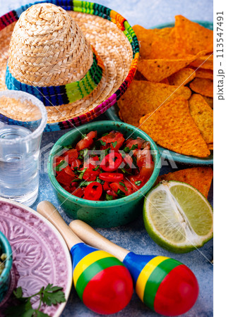 Traditional Mexican food nachos, salsa, guacamole, tequila. 113547491