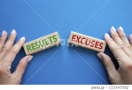 Results or Excuses symbol. Concept word Results or Excuses on wooden blocks. Businessman hand. Beautiful blue background. Business and Results or Excuses concept. Copy space 113547592