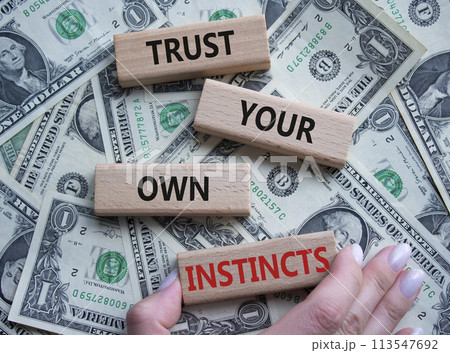 Trust your own Instincts symbol. Concept words Trust your own Instincts on wooden blocks. Beautiful dollar background. Businessman hand. Business and Instincts concept. Copy space. Trust your own Instincts symbol. Concept words Trust your own Instincts on wooden blocks. Beautiful dollar background. Businessman hand. Business and Instincts concept. Copy space. 113547692