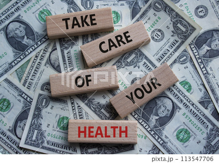 Health symbol. Wooden blocks with words Take Care of your Health. Beautiful dollar background. Health concept. Copy space. Health symbol. Wooden blocks with words Take Care of your Health. Beautiful dollar background. Health concept. Copy space. 113547706