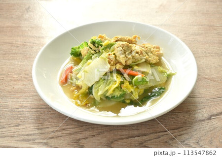 fried white Chinese cabbage with egg in soy sauce on plate 113547862
