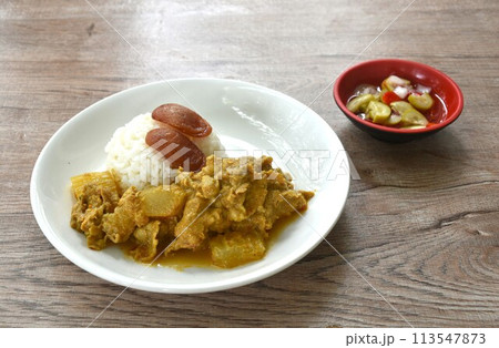 spicy bailed winter melon with pork curry soup eat couple rice on plate dipping  sweet chili syrup sauce  113547873