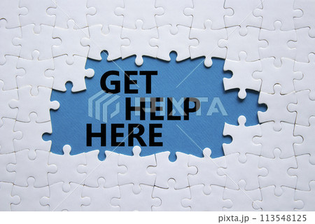 Get help here symbol. White puzzle with words Get help here. Beautiful blue background. Business and Get help here concept. Copy space. 113548125
