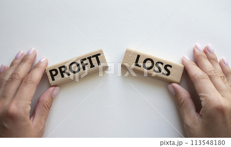 Profit or Loss symbol. Concept word Profit or Loss on wooden blocks. Businessman hand. Beautiful white background. Business and Profit or Loss concept. Copy space 113548180