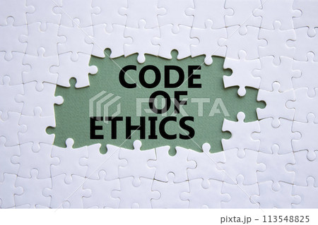 Code of ethics symbol. Concept words Code of ethics on white puzzle. Beautiful grey green background. Business and Code of ethics concept. Copy space. Code of ethics symbol. Concept words Code of ethics on white puzzle. Beautiful grey green background. Business and Code of ethics concept. Copy space. 113548825