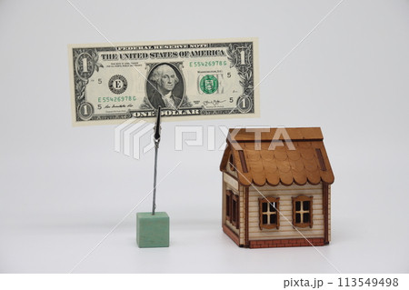 The toy house stands next to the banknote on the stand. Accurate financial calculation The toy house stands next to the banknote on the stand. Accurate financial calculation 113549498