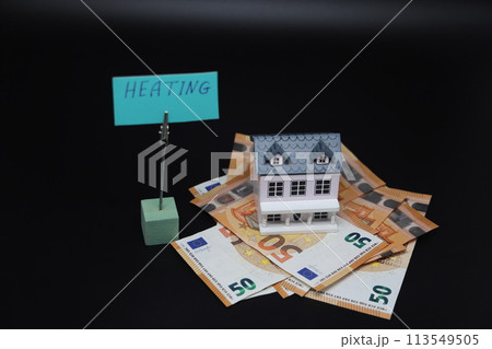 Toy house on banknotes and heating plate. The concept of increasing prices for electricity and gas. 113549505
