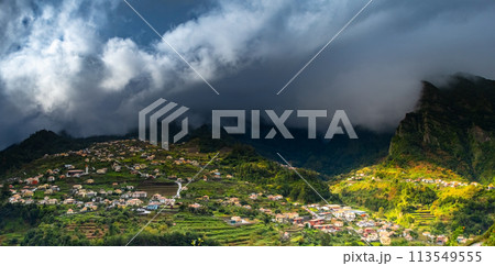 Traditional terrace village Sao Vicente, Madeira Island, Portugal. Small houses and gardens among a green mountain landscape in stormy weather. Traditional terrace village Sao Vicente, Madeira Island, Portugal. Small houses and gardens among a green mountain landscape in stormy weather. 113549555