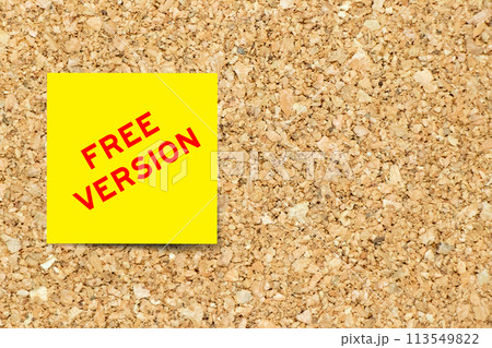 Yellow note paper with word free version on cork board background with copy space Yellow note paper with word free version on cork board background with copy space 113549822