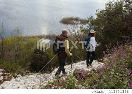 senior couple hiking outdoor, man and woman norwegian walking with sticks landscape senior couple hiking outdoor, man and woman norwegian walking with sticks landscape 113551338