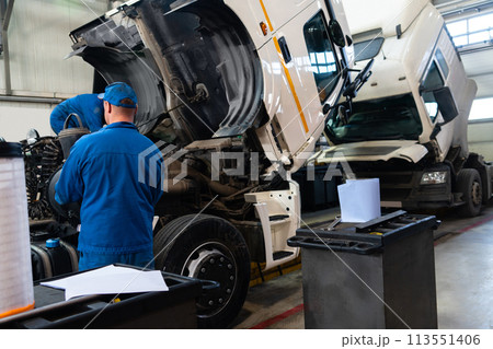 Truck repair service indoors. Maintenance workshop. Truck repair service indoors. Maintenance workshop. 113551406