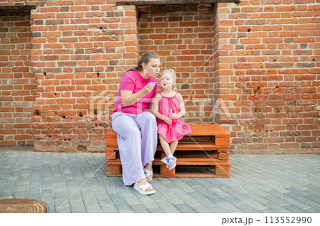 Mother holds and have fun her child with hearing aids and cochlear implants summer outdoor . Deaf and health concept. Diversity and inclusion. Copy space Mother holds and have fun her child with hearing aids and cochlear implants summer outdoor . Deaf and health concept. Diversity and inclusion. Copy space 113552990