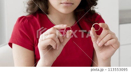Young girl holding wedding rings Young girl holding wedding rings 113553095