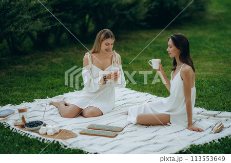 Two young women meditate and do yoga in nature. Two young women meditate and do yoga in nature. 113553649