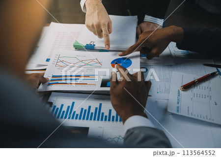 Business idea. Business people talking And calculations about charts and graphs showing the growth of investment results Of successful teamwork Business idea. Business people talking And calculations about charts and graphs showing the growth of investment results Of successful teamwork 113564552