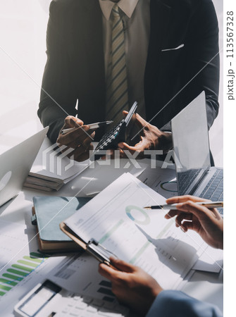 Business team meeting present, investor colleagues consultation and conference new strategy plan business and market growth on financial document graph report, Meeting and Talking. Business team meeting present, investor colleagues consultation and conference new strategy plan business and market growth on financial document graph report, Meeting and Talking. 113567328