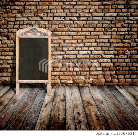 Interior scene with brick wall, wooden floor, advertising billboard in retro style chalkboard in wooden frame. Open space with old wall, wooden floor, cafe menu or pointer board. 3d render 113567631