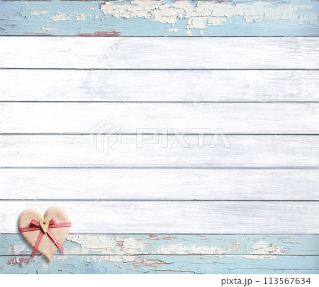 Vintage travel backdrop with heart made of linen tissue on wood boards of white and light blue color.  Horizontal retro background with old wooden planks and tiny toy heart. Copy space for text 113567634