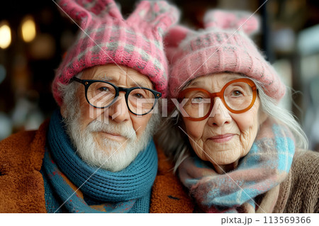 Happy old couple in bunny ears on festive background. Easter concept Happy old couple in bunny ears on festive background. Easter concept 113569366
