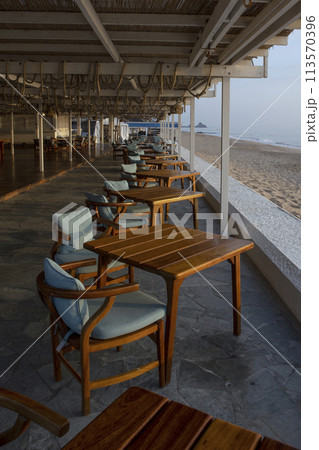 Restaurant with sea view. Empty tables at dawn. Without people. 113570396