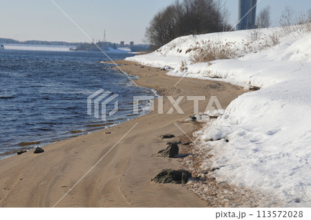 nature in winter on the banks of the Volga, ice with sand and snow, river sandy background. 113572028