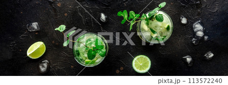 Mojito cocktail. Summer cold drink with lime, fresh mint, and ice. Cool beverage Mojito cocktail. Summer cold drink with lime, fresh mint, and ice. Cool beverage 113572240
