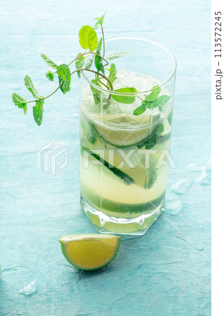 Mojito cocktail. Summer cold drink with lime, fresh mint, and ice. Cool beverage Mojito cocktail. Summer cold drink with lime, fresh mint, and ice. Cool beverage 113572245