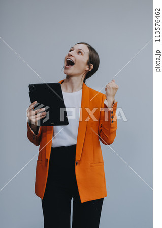 Smiling caucasian young woman girl freelancer student using digital tablet, having idea, pointing upwards on copyspace, surfing on social media, mobile applications, e-learning isolated in white 113576462