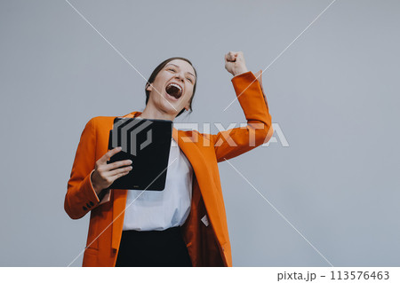 Smiling caucasian young woman girl freelancer student using digital tablet, having idea, pointing upwards on copyspace, surfing on social media, mobile applications, e-learning isolated in white Smiling caucasian young woman girl freelancer student using digital tablet, having idea, pointing upwards on copyspace, surfing on social media, mobile applications, e-learning isolated in white 113576463