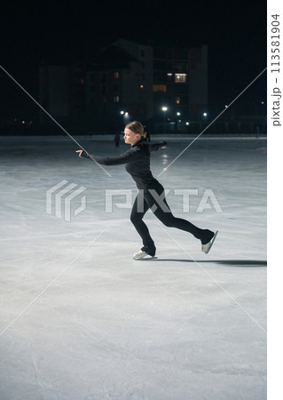 Beautiful young woman ice skating Beautiful young woman ice skating 113581904