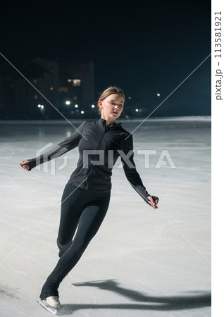 Beautiful young woman ice skating Beautiful young woman ice skating 113581921