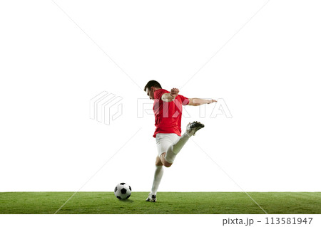 Focused and competitive young male soccer player in motion during football game on field, hitting ball isolated on white background Focused and competitive young male soccer player in motion during football game on field, hitting ball isolated on white background 113581947
