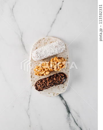 Healthy eclairs or profitroles on marble background Healthy eclairs or profitroles on marble background 113582331