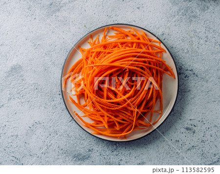 Raw carrot noodles or spaghetti, top view Raw carrot noodles or spaghetti, top view 113582595