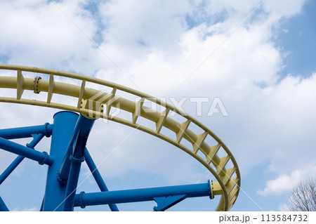 Yellow and blue track for the ride in amusement park against blue sky 113584732