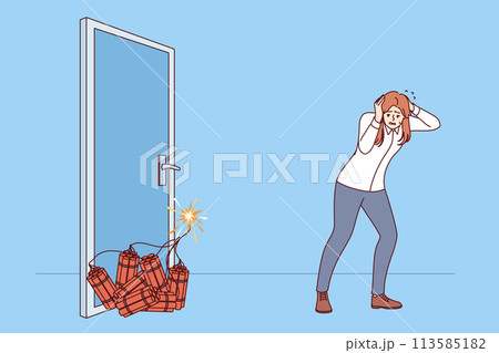 Woman manager sets off explosion to open door, covers ears with hands while standing near dynamite 113585182